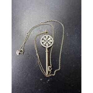 Gold over sterling silver key pendant necklace with Cz stones